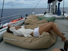 two women lounging on the back of a boat