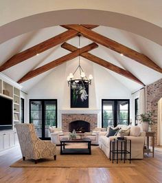 a living room filled with furniture and a fire place in the middle of a room