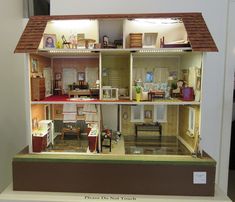 a doll house with all the furniture and accessories in it's own display case