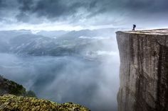 a person standing on the edge of a cliff