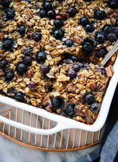 blueberry baked oatmeal in a white baking dish on a wire rack