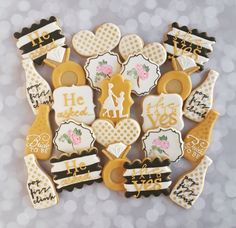 decorated cookies are arranged in the shape of heart and bottle openers with words on them