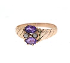 This lovely edwardian era ring features two vibrant purple oval amethysts. They measure about 5x3mm and are set horizontally. Between the two gemstones are two delicate seed pearls. The ring is a beautiful rosey gold. probably 12-14k. Hand engraved detail on each side add uniqueness to this vintage ring. It is perfect for a February birthstone ring.Size: 5.25 - Sizing smaller and larger up to two sizes is included. For larger sizes please inquire. Please see the Additional Policies section for m Antique Oval Three Stone Rings, Victorian Three Stone Oval Ring, Antique Oval Amethyst Multi-stone Ring, Heirloom Multi-stone Oval Amethyst Ring, Heirloom Oval Multi-stone Amethyst Ring, Victorian Oval Birthstone Ring, Classic Oval Multi-stone Amethyst Ring, Oval Three Stone Amethyst Ring, Fine Jewelry, Oval Three Stone Amethyst Ring