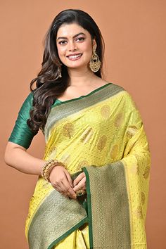 The Lemon yellow color viscos georgette saree is crafted with golden zari weaved motif and buti work all over the body. Contrast green color pallu and the border is crafted with golden zari weaved designer work. Blouse piece attached. This saree is in trend, and a replica of the pure one. Get the feeling of a pure khaddi saree, yet in budget with this comfortable, light weight and stylish saree which is perfect for any party occasion. Buy this lemon yellow color contrast khaddi georgette saree i Khaddi Georgette Saree, Lemon Yellow Color, Stylish Saree