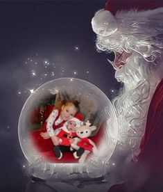 a santa clause holding a baby in a snow globe