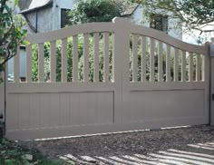 a wooden gate in front of a house