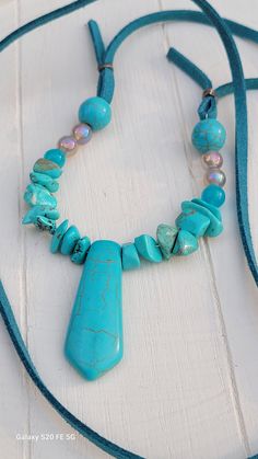 Turquoise beads, chips, blue jade, Grey agate beads on a teal color suede rope.  Long enough to easily slide on over your neck.  No clasp.  Perfect for the boho-hippie look.  Christmas gift for her or self. Turquoise Dangle Necklaces With Gemstone Beads, Turquoise Gemstone Beads Dangle Necklace, Adjustable Turquoise Beaded Necklace With Natural Stones, Unique Adjustable Turquoise Necklace, Unique Adjustable Turquoise Gemstone Beads Necklace, Adjustable Turquoise Beaded Necklace With Gemstone, Adjustable Dangle Turquoise Necklace As Gift, Adjustable Turquoise Beaded Gemstone Necklace, Turquoise Pendant Beaded Necklace With Adjustable Fit