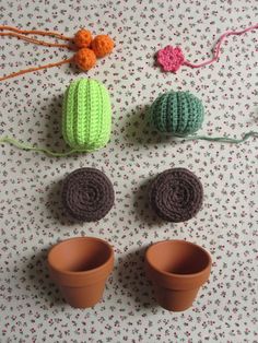 crocheted pots and yarns are arranged on a table