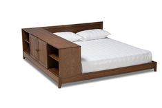 a wooden bed with white sheets and pillows