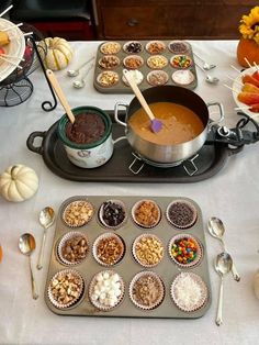 a table topped with muffins and cupcake tins filled with different types of food