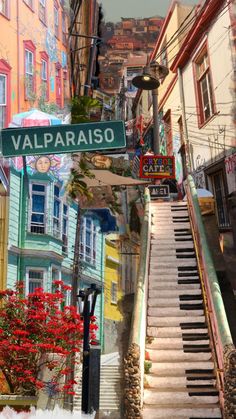 a street sign that reads valparaaiso on the side of a building with stairs leading up to it