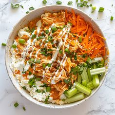 a bowl filled with carrots, celery and other vegetables