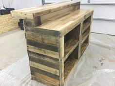 the pallet desk is made out of wood and has two shelves on each side