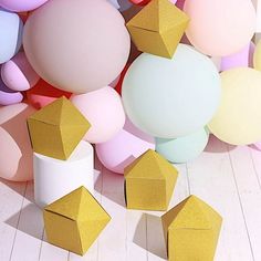 many different colored balloons and shapes on the floor