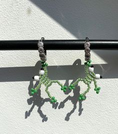 Handmade pair of earrings with green beaded frogs. These little frog earrings are perfect for all frog lovers and makes a great gift.  Earrings (frogs) are made with seed glass beads and wire. Earring itself is copper alloy and it contais cubic zirconia stones. Diameter for rings: 13mm Frog is 22mm long   PLEASE NOTE: this is not a toy and is not suitable for young children. Earrings are handmade with delicate glass beads and wire and will break if not cared for properly. Do not bend the frogs e Whimsical Green Dangle Jewelry, Green Dangle Metal Hoop Earrings, Green Metal Dangle Hoop Earrings, Green Dangle Hoop Earrings In Metal, Unique Green Hoop Earrings, Trendy Green Dangle Hoop Earrings, Unique Green Hoop Jewelry, Handmade Green Metal Hoop Earrings, Frog Earrings