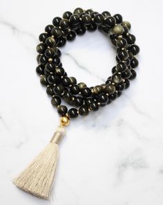 'I am empowered to pursue my passions.' Gold Sheen Obsidian, also known as the "wizard stone," has a long history of being used as a scrying mirror for divination and future prediction. Its reflective surface helps to bring clarity to the mind and alleviate confusion, allowing for deep introspection and personal growth. The reflective nature of Gold Sheen Obsidian has made it a popular tool for self-reflective meditation and fostering internal growth and understanding. Its properties also promot Spiritual Obsidian Jewelry With Natural Stones, Gold Spiritual Obsidian Jewelry, Spiritual Onyx Beads Jewelry 8mm, Spiritual Obsidian Jewelry For Meditation, Bohemian Obsidian Jewelry For Healing, Spiritual Obsidian Round Bead Jewelry, Spiritual Obsidian Jewelry With Round Beads, Obsidian 8mm Beads Jewelry For Meditation, Obsidian Beads Jewelry For Meditation