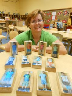 a woman sitting at a table with some pictures on it