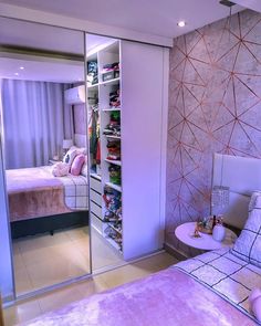 a bedroom with mirrored closet doors in it