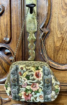 This exquisite evening purse hails from the opulent era of the 1920s and was skillfully crafted by Metro Bag Works in France. Its intricate design showcases a beautiful silk-woven and embroidered floral motif, accented with shimmering metallic silver and gold threads. The purse is adorned with a metal frame featuring delicate rosettes, adding to its timeless elegance. Luxury Antique Handmade Bags, Art Deco 1920s, Tapestry Bag, Evening Purse, Gold Threads, Showcase Design, Clutch Handbag, Floral Motif, Evening Bags