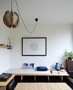 a living room with white walls and black carpet