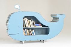 a blue whale shaped book shelf with books on it