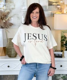 The Jesus Is Lord Graphic Shirt boldly proclaims faith with the words "Jesus is Lord," making it a meaningful piece to wear as a declaration of your beliefs. Available in sizes YXS-5XL, this shirt comes in short sleeve, long sleeve, and sweatshirt options, allowing you to wear your faith comfortably in any season. It's a perfect way to shine for Jesus and share the message of God wherever you go! Online Shop Website, Jesus Graphic, Christian Graphic Design, Christian Products, Shop Website, Monogram Shirts, Black Friday Christmas, Rain Gear, Jesus Is Lord