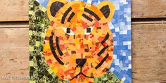 a paper collage of a tiger on wood with blue and orange squares in the background