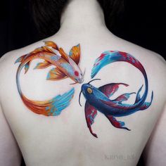 two colorful fish on the back of a woman