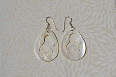 These beautiful earrings feature a hand carved white mother of pearl in a floral design. . The iridescence of the Mother of Pearl Shell l is really amazing. Depending on the light source they will radiate colors varying from whites to creamy whites . The shells are then polished to a high gloss to reveal the beauty of their natural pattern. Enjoy these lightweight beauties that are so easy to wear. these beach earrings are perfect for everyday and any occasion. DETAILS - Shell types : White Moth Handmade White Mother Of Pearl Earrings, Handmade White Earrings In Mother Of Pearl, Unique White Pearl Earrings For Pierced Ears, Unique White Pearl Earrings, Delicate White Pearl Pierced Earrings, Bohemian White Mother Of Pearl Earrings, White Mother Of Pearl Round Earrings, Vintage White Pearl Pierced Earrings, White Mother Of Pearl Earrings