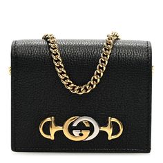 This is an authentic GUCCI Grainy Calfskin Zumi Chain Card Case Wallet in Black. This stylish cardholder is crafted of black grained calfskin leather. The wallet features a prominent polished gold and silver GG monogram horse-bit detail on the front and a small gold chain strap. The wallet opens to a black leather interior with card slots, a billfold, and a zipper compartment. Small Gold Chain, Gg Monogram, Card Case Wallet, Horse Bits, Gucci Wallet, Leather Interior, Gold And Silver, Chain Strap, Card Case