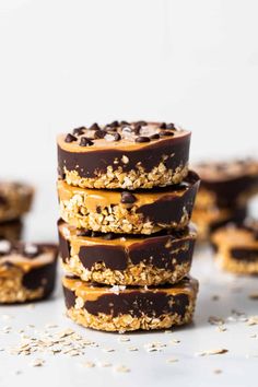 chocolate covered cookies stacked on top of each other with oats and peanut butter in the middle