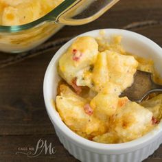 a bowl filled with macaroni and cheese on top of a wooden table