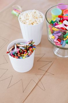 two bowls filled with different colored candies on top of a table