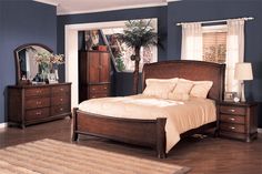 a bedroom with blue walls and wooden furniture