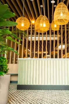 the lights are hanging from the ceiling above the counter in the restaurant's dining area