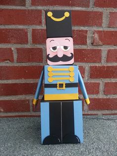 a wooden toy soldier with a mustache and moustache on it's face