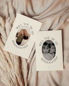 two personalized greeting cards on a bed next to some dried up grass and feathers