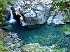 there is a small waterfall in the middle of some rocks