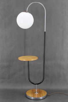 a table lamp with a wooden base and a white ball on top