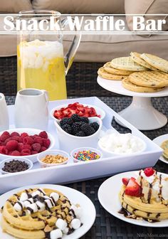 a table topped with lots of desserts and waffles on top of plates