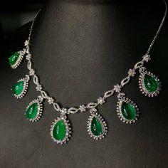 "\"The Teardrop Emerald Necklace\" - Worldclass masterpiece! THIS SET IS A MUST HAVE FOR ANY JEWELRY COLLECTOR! HUGE AND SPARKLING! Vivid green emeralds with full gemological certificates! Surrounded by almost 14 carats of DIAMONDS! Glamorous! Set in one of a kind, elegant 18K solid white gold, handmade settings! Suggested Retail price: $65,000 USD NECKLACE & PENDANT: Central emerald: 8.80 carats! Vivid green, with great translucency. Accented Cabochon Teardrop Emeralds: 6 pieces: 35.21 cara