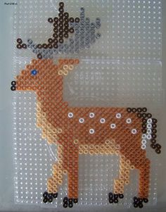 the beaded deer is standing in front of a white background with brown dots on it