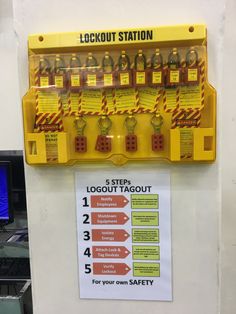 a yellow machine with instructions on how to use the lockout station