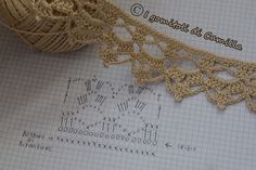 crocheted doily on top of a sheet of paper with letters and numbers