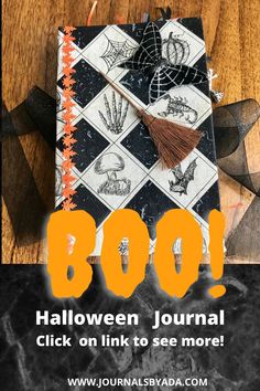 a halloween journal with the words boo on it and an orange tassel hanging from the cover