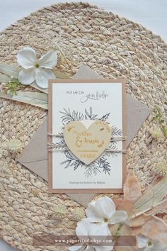 a close up of a card on a plate with flowers and ribbon around it's edges