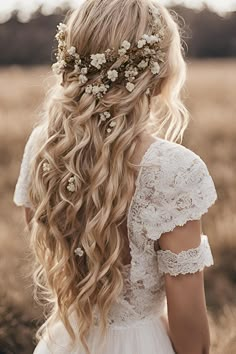 a woman with long blonde hair and flowers in her hair, wearing a white dress