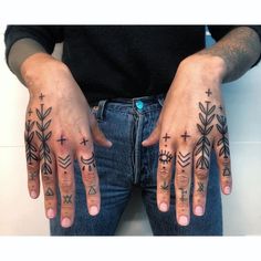 two hands with cross tattoos on them