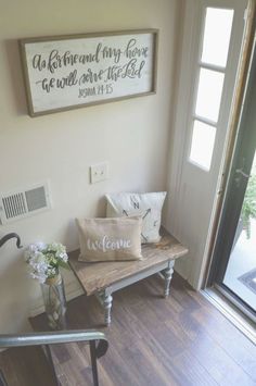 a wooden bench sitting in front of a window next to a wall with a sign on it