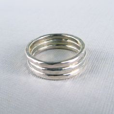 Wear this 2mm wide ring alone or stack a few together. This ring will be made to order for you in your choice of style and finish, and in the whole, half, or quarter size you need. Style choices are: hammered (a classic hammered texture) bottom ring in first picture smooth (no hammering, round profile) middle ring in first picture extra textured (hammered with more texture) top ring in first picture Finish options are: bright shiny silver satin silver oxidized and sanded (blackened, then brushed Round Profile, Multiple Earrings, Flat Wire, Sterling Silver Stacking Rings, Top Rings, Wide Ring, Silver Stacking Rings, Wide Rings, One Ring